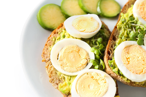 Plate of tasty toasts with boiled egg on white background, closeup - Photo, Image
