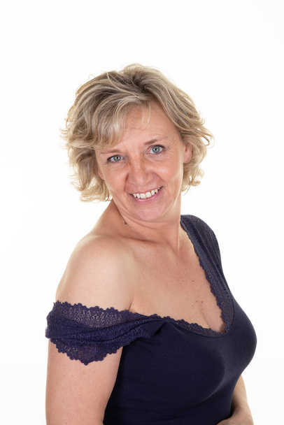 blond portrait of 60 sexy senior happy woman smiling on white background - Foto, afbeelding