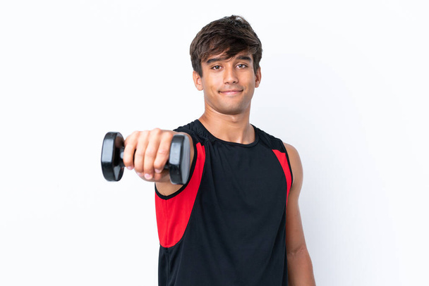 Young caucasian man isolated on white background making weightlifting - Foto, afbeelding