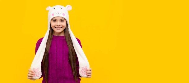 teen girl in knitwear. express positive emotion. positive child in earflap hat. Banner of christmas child girl, studio kid winter portrait with copy space - Photo, Image