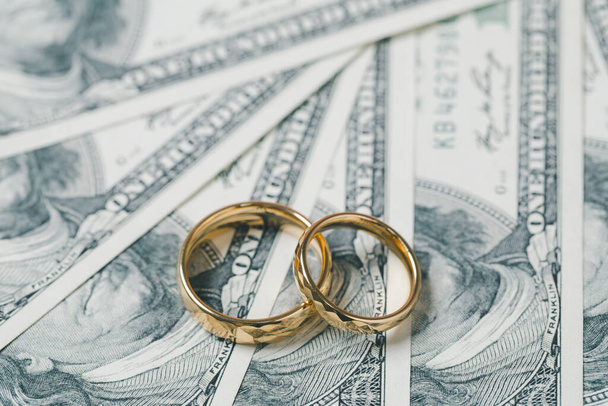 Save money and planning wedding concept. Sustainable financial goal for family life or married life. Rings with stack of coins, saving money for marry, depicts savings or growth for new family. - Fotó, kép