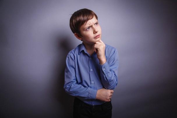 boy holds his hand chin thinking - Photo, Image