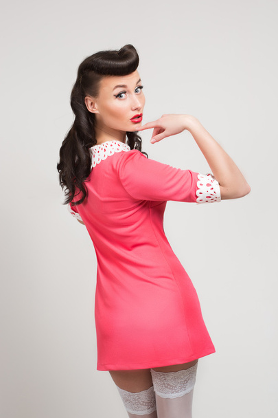 emotional sexy pin-up girl in coral dress - Photo, image