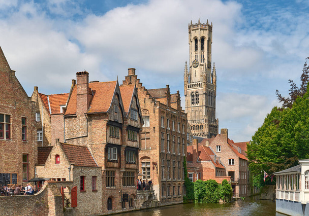 Bruges, Belgium - July 18, 2020:  Medieval architectures of the old town with  the Berlfry medieval bell tower - Φωτογραφία, εικόνα