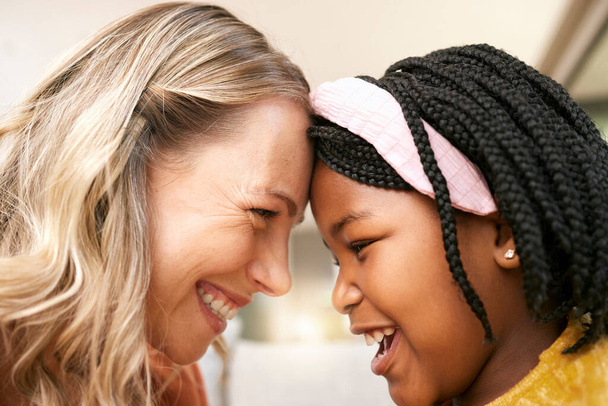 Bonding, love and girl with a foster mother for safety, care and happiness in a family home. Foster care, happy and African girl with a smile for her mom on mothers day, playful and crazy together. - Photo, image