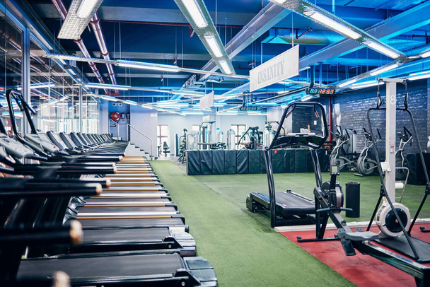 Empty gym, equipment and studio for fitness, exercise and sports or wellness training indoors. Treadmill, machines and health center for workout, athletics and motivation for race or marathon. - Photo, Image