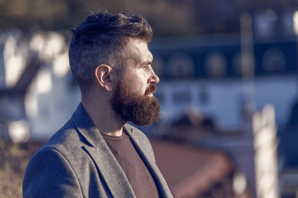 His bearded hair look styled. Bearded man outdoor. Bearded hipster in casual business style. Brutal guy wear mustache and beard on bearded face. Barbershop. Beard grooming. - Foto, afbeelding