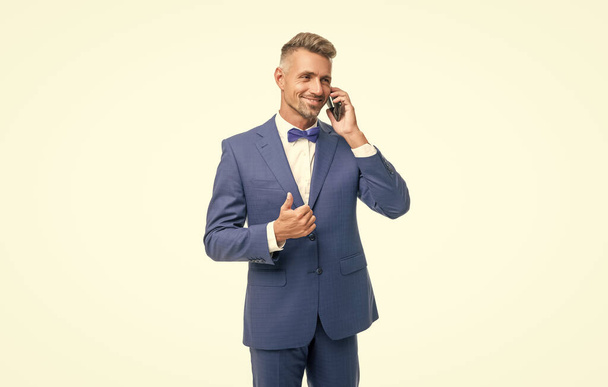 cheerful man in blue bow tie suit talk on phone isolated on white. - Fotografie, Obrázek