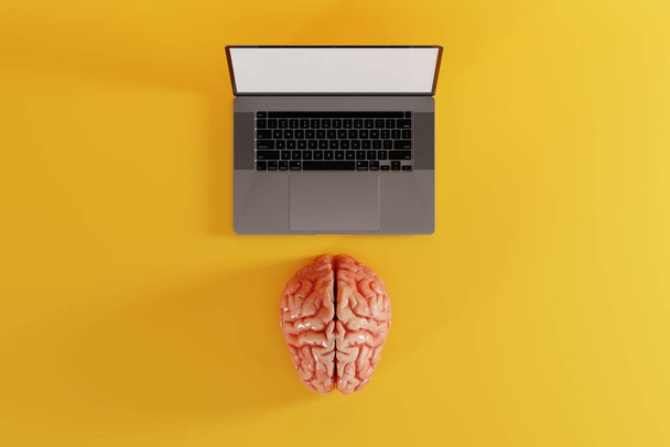 Mozek ležící před počítačem na žlutém pozadí. Koncept propojení mozku s počítačem, vědomí. 3D vykreslení. - Fotografie, Obrázek