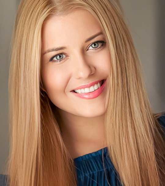 Beauty and femininity, beautiful blonde woman with long blond hair smiling, natural portrait closeup - Fotó, kép