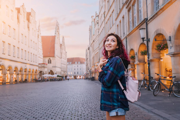 Boldog turista nő látogat Prinzipalmarkt utca és megcsodálják a régi város építészeti épületek Munster, Németország - Fotó, kép