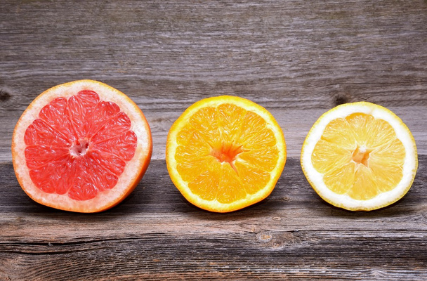 Citrus fruits on wooden background. Orange, grapefruit, lemon - 写真・画像