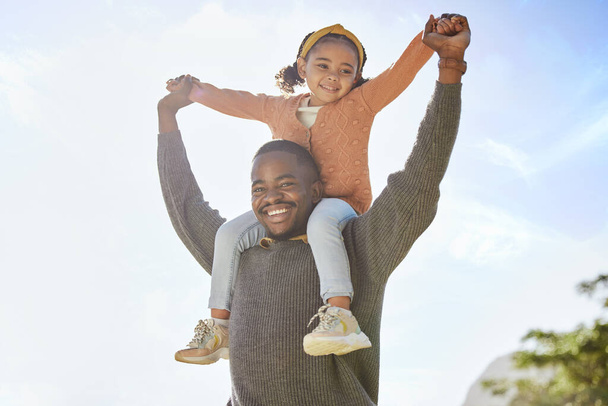Father, child and smile holding hands for piggyback, love and support for parenting, childhood or trust in the outdoors. Happy dad carrying kid smiling on shoulders for family bonding time in nature. - Photo, Image