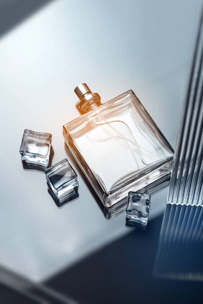 Stylish composition with a man perfume bottle on a glass table. Luxury atmosphere. Vertical photography. - Zdjęcie, obraz