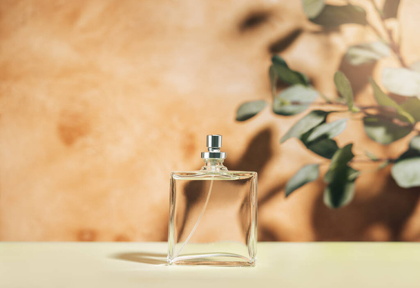 Transparent perfume bottle on a mediterranean style background. Front view. - Foto, imagen