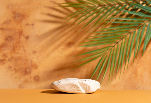 Natural empty background for cosmetic product presenation, packaging mockup made with stone and palm leaves. Minimal nature scene. Front view, copy space. - Fotografie, Obrázek