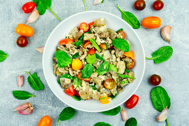 Warm salad of baked aubergine, tomato and spinach. - Photo, Image