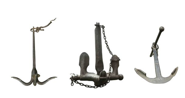 Iron black old rusty naval anchor isolated on a white background. - 写真・画像