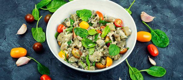 Tasty salad of baked eggplant, tomato and spinach. - Photo, Image