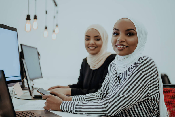 beautiful modern African American Muslim businesswoman in office, wearing hijab at creative modern startup coworking space. High quality photo - Foto, imagen