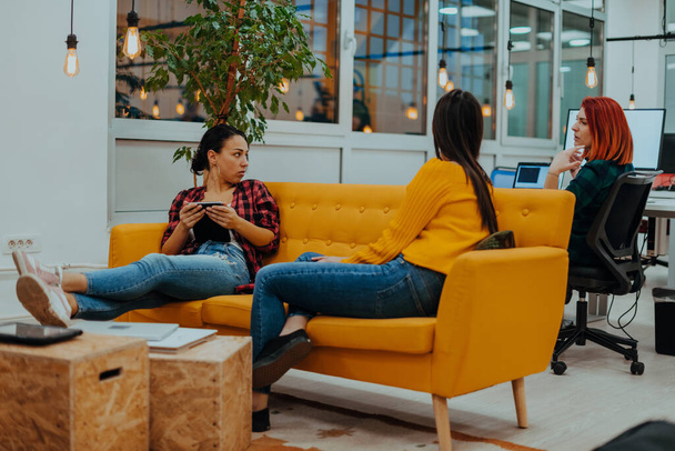 group of female friends having a team meeting and discussion about project or gossip chatting in modern startup business office. High quality photo - Fotó, kép
