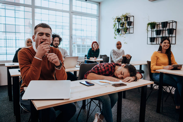 Tired woman napping on the table during a lecture in the classroom. High quality photo - Foto, Bild