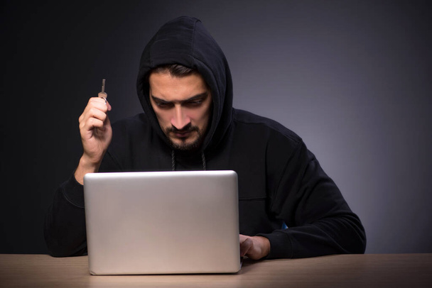 Young hacker on grey background - Photo, Image