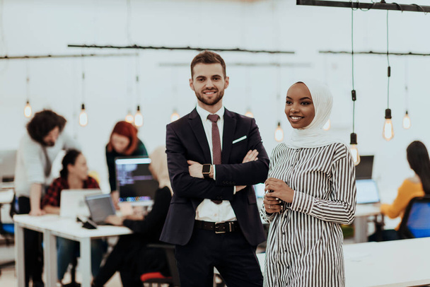 Portrait of a formal businessman and young African American businesswoman posing with their team in a modern startup office. Marketing concept. Multi-ethnic society - Foto, imagen