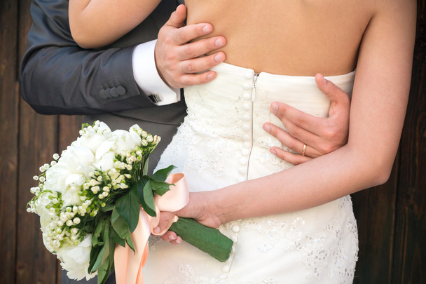 Married couple embraced, detail of the bust and arms - Photo, Image