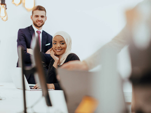 Portrait of a formal businessman and young African American businesswoman posing with their team in a modern startup office. Marketing concept. Multi-ethnic society - Photo, image