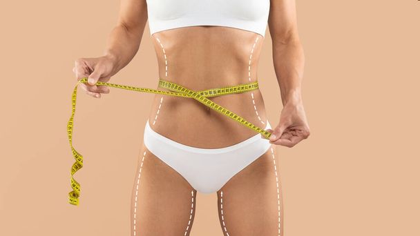 Dieting Concept. Unrecognizable Female In Underwear Checking Waist Size With Measuring Tape, Young Slim Woman With Lifting Lines And Arrows On Skin Standing Isolated Over Beige Background, Collage - Valokuva, kuva