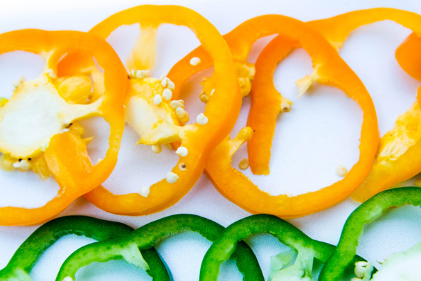 green, orange bell pepper slices - 写真・画像
