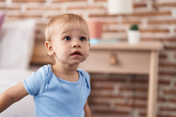 Adorable toddler standing with relaxed expression at bedroom - Фото, зображення