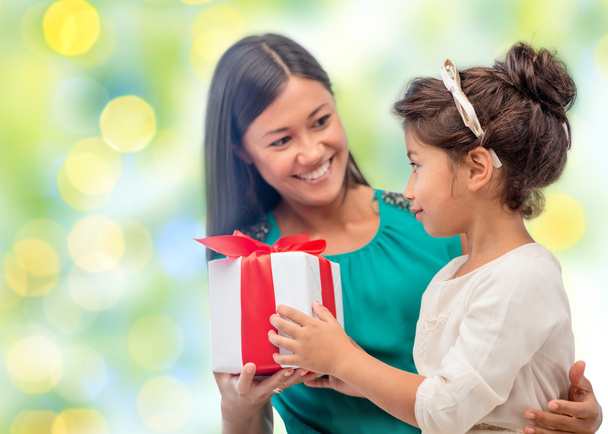happy mother and daughter with gift box - 写真・画像