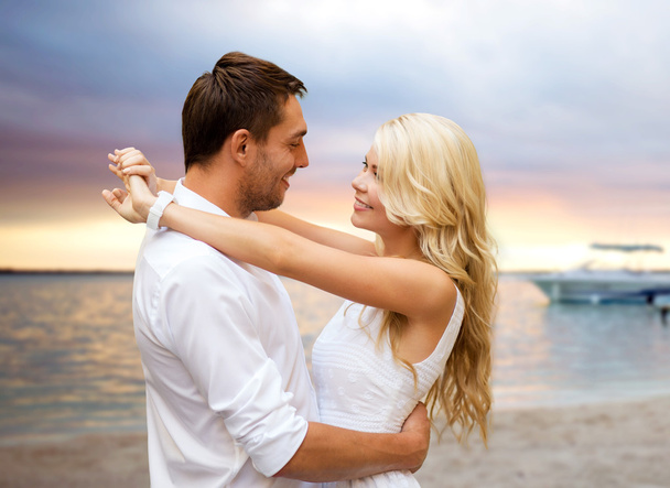 happy couple hugging over sunset beach background - Photo, Image