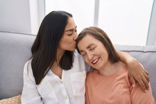 Two women mother and daughter sitting on sofa together at home - Foto, immagini