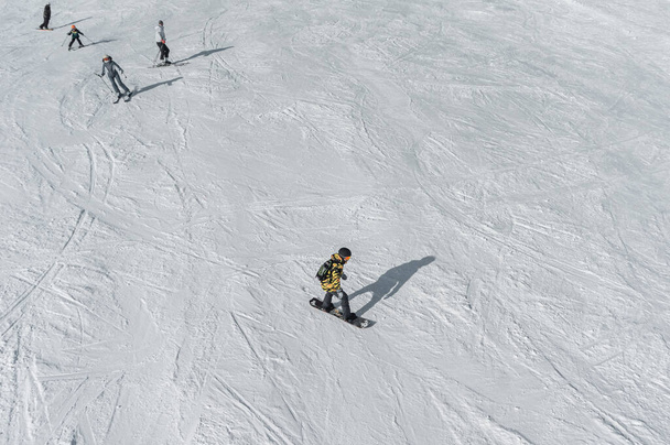 skiers and snowboarders skiing in alpine snowy hills - Foto, Imagen