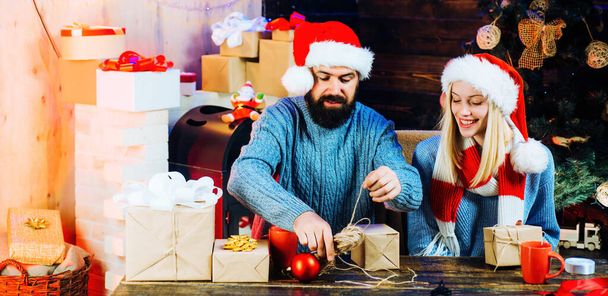 Home Christmas atmosphere. New Year concept. Couple or young family celebrating Merry Christmas and Happy New Year. Couple prepare christmas decorations - 写真・画像