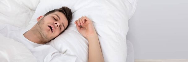 Man Snoring While Sleeping. Young Person On Pillow - Φωτογραφία, εικόνα