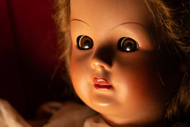 Scary vintage doll in half light. Close up - Foto, Imagen