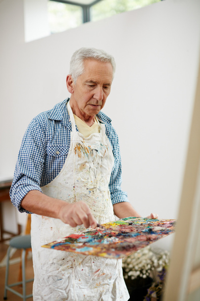 I was created to create. a senior man working on a painting at home - Fotoğraf, Görsel