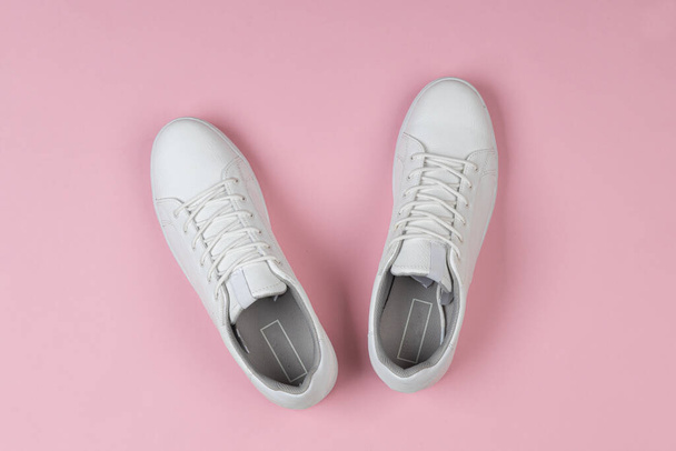 Pair of new white sneakers on pink background - Foto, Imagem