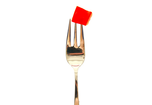 Fork with a red pepper slice isolated on white background. - Фото, изображение