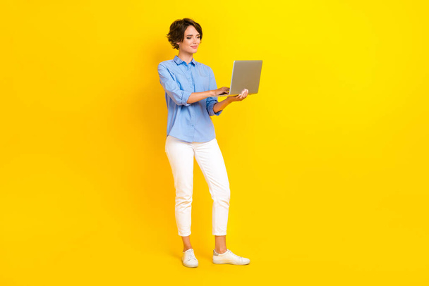 Full size photo of nice cute woman with bob hairdo dressed hold notebook video conference meeting isolated on yellow color background. - Fotó, kép