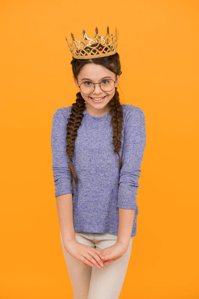 Princess who always smiles. Happy princess yellow background. Princess girl wear luxury crown. Beauty look of little princess. Hair salon. Prom party. Fashion accessories. Shine the moments. - Foto, Imagem