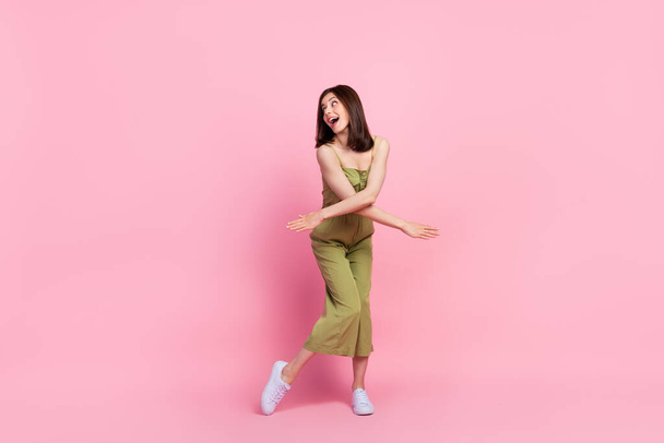Full length photo of overjoyed crazy lady enjoy night party club interested look empty space isolated on pink color background. - Foto, afbeelding