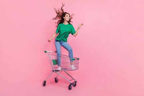 Photo of crazy funky lady stand trolley ride go move look way mall center empty space hurry black friday isolated on pink color background. - Foto, immagini