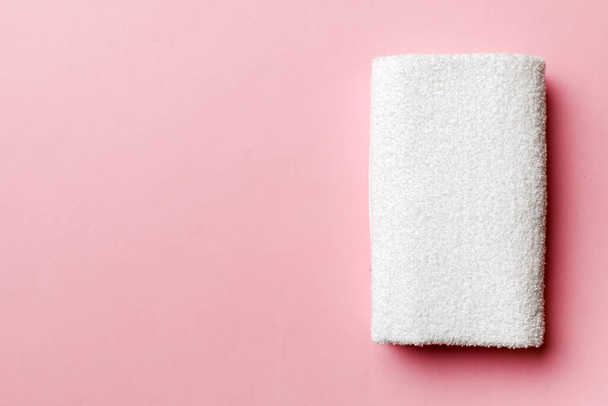 Top view of white towels with copy space on colored background. - 写真・画像