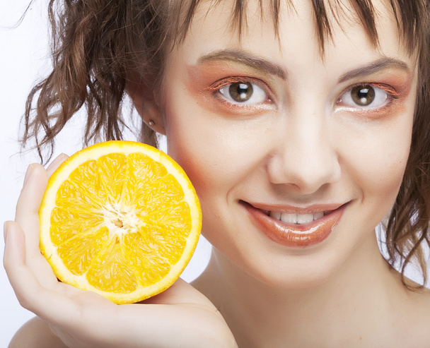 womans face with juicy orange - Zdjęcie, obraz