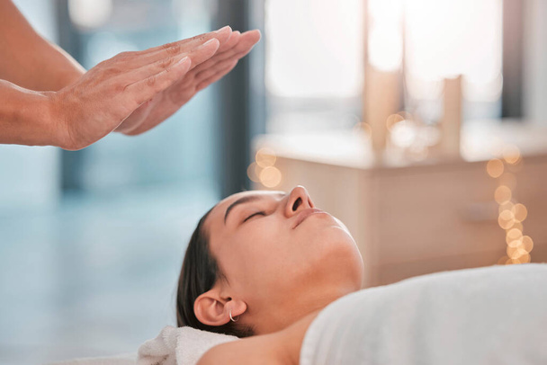 Hands, relax woman or reiki spa for headache pain relief, depression healing or stress management in healthcare wellness or holistic clinic. Man, energy healer or mind chakra aura cleanse on patient. - 写真・画像